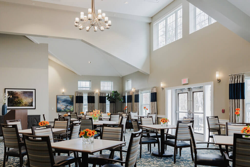 Dining room view with vaulted ceilings and chandelier