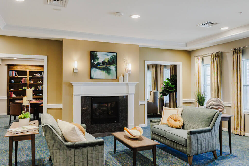 Sitting room in AAAL Tinton Falls, with a gorgeous double sided fireplace