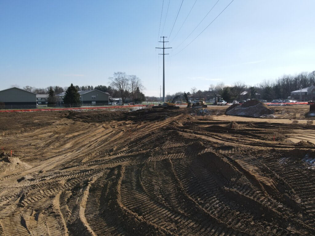 Wide shot of the pond being rough cut at the AHEPA 100-II Senior Apartment construction site