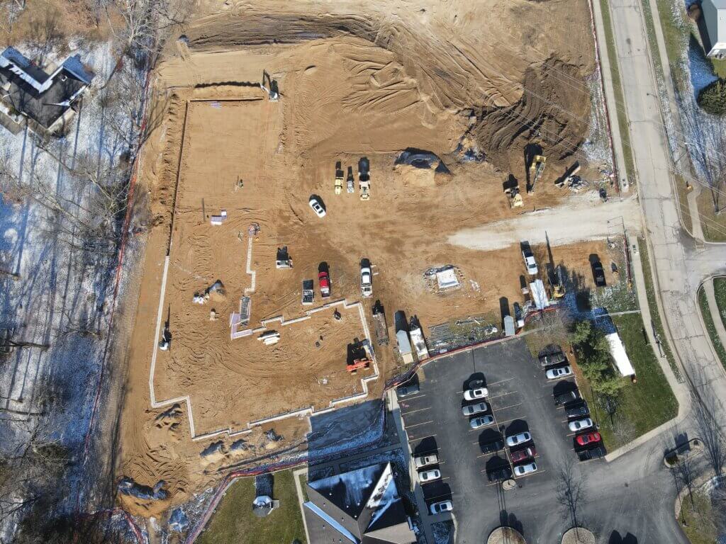 An aerial image of the south side of AHEPA 100-II Senior Apartments construction site during the early stages, showing off progress of footer construction